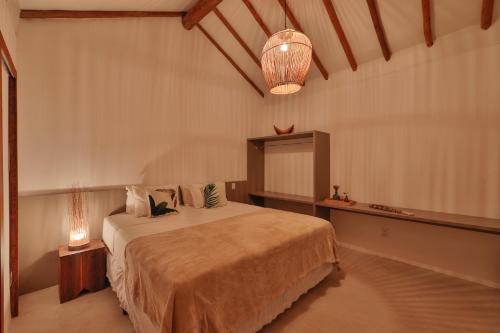 a bedroom with a large bed in a room at Pousada Tatuá in Pôrto de Pedras
