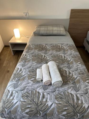 a bedroom with a bed with two towels on it at LOCANDA LA CAMPAGNOLA orari check in dalle 1130 alle 1530 e dalle 1830 alle 2330 in Vignola