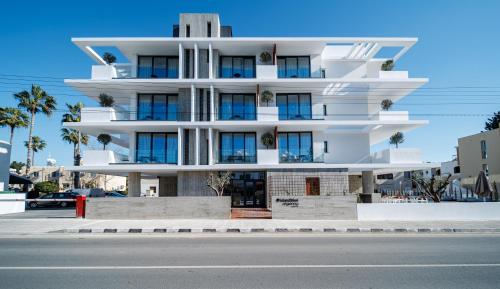 a white building on the side of a street at Regency Boutique Hotel Holiday Suites in Paphos