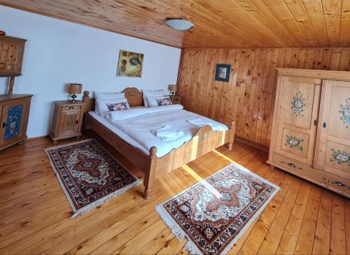 a bedroom with a bed and a wooden ceiling at Casa RAI in Predeal