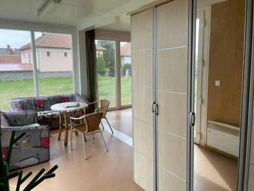 a living room with a table and a couch at LakePark Apartman in Bekecs