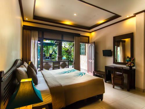 Postel nebo postele na pokoji v ubytování De Munut Balinese Resort