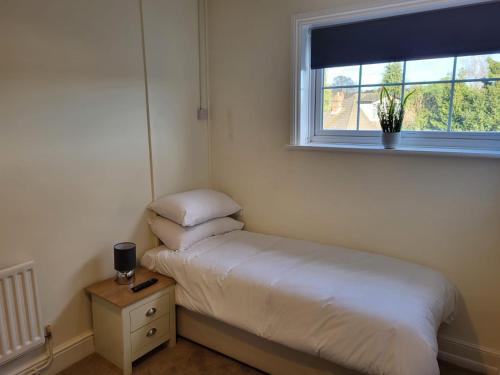 a small bedroom with a bed and a window at The Bird in Hand in Stourport