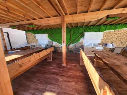 a large room with wooden tables and green walls at Вилно селище PARADISE VIEW in Sarnitsa