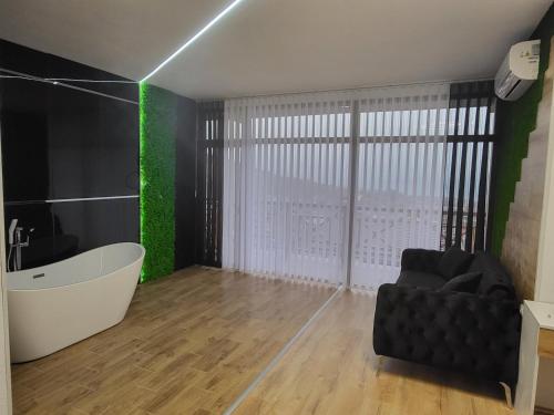 a bathroom with a bath tub and a bath chair at Вилно селище PARADISE VIEW in Sarnitsa