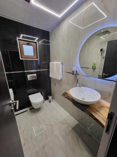 a bathroom with a white sink and a mirror at Вилно селище PARADISE VIEW in Sarnitsa