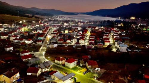 a large city with a town at night at Вилно селище PARADISE VIEW in Sarnitsa