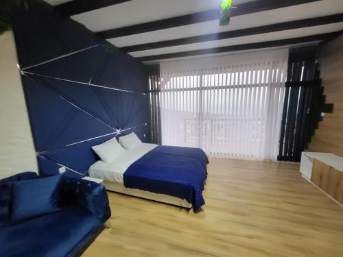 a bedroom with a bed and a couch at Вилно селище PARADISE VIEW in Sarnitsa