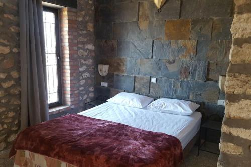 a bedroom with a bed in a brick wall at studio en pierres traditionnelle in Essaouira