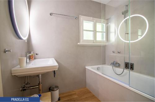 a bathroom with a sink and a shower and a tub at Chalet Pradella by Arosa Holiday in Arosa