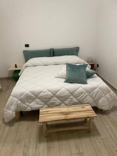 a bedroom with a large bed with a wooden foot board at B&B Archimede in Scanzano