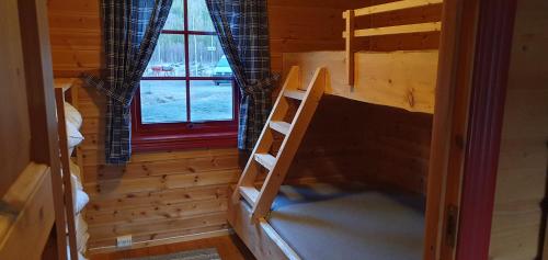 a room with a bunk bed and a window at Visit Junkerdal in Junkerdal