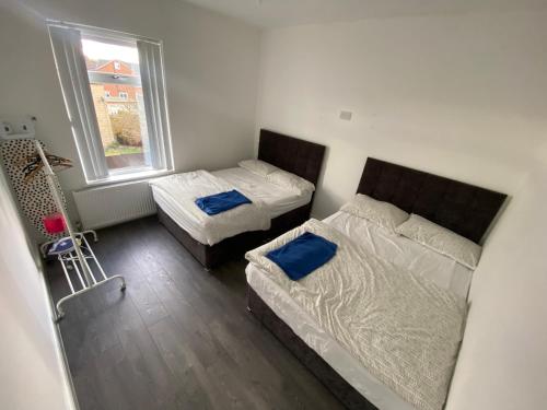 a small bedroom with two beds and a window at Entire Holiday Home in Mirfield