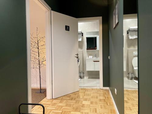 a bathroom with a white door and a toilet at Premium Apartments in Gjakove