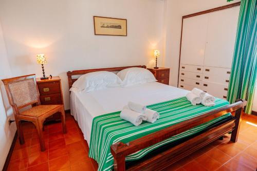 a bedroom with a bed with towels on it at Tenuta Delle Ripalte in Capoliveri