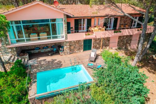 an aerial view of a house with a swimming pool at Tenuta Delle Ripalte in Capoliveri
