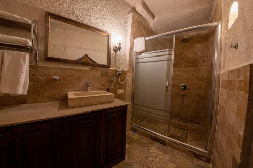 a bathroom with a sink and a shower at Hidden Cave Hotel in Goreme