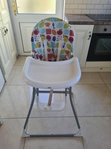 a high chair with a colorful seat in a kitchen at Bundoran Seaside Stays House - WiFi, large spacious home in Bundoran