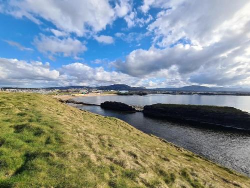 a body of water with rocks in the water at Bundoran Seaside Stays House - WiFi, large spacious home in Bundoran