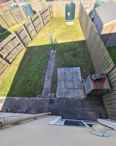 an aerial view of a backyard with a fence at Bundoran Seaside Stays House - WiFi, large spacious home in Bundoran