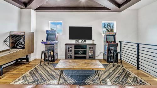 a living room with a couch and a tv at Luxury (Less than mile from AT&T Stadium/GlobeLife) GameRoom/Basketball Hoop in Arlington