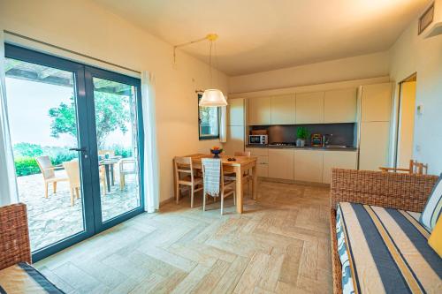 a living room with a kitchen and a dining room at Tenuta Delle Ripalte in Capoliveri