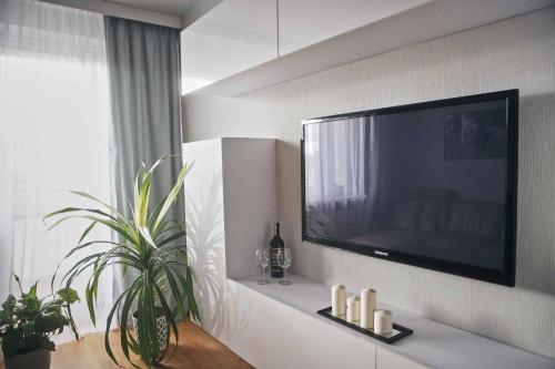 a living room with a large flat screen tv on a wall at Mieszkanie nad Maltą in Poznań
