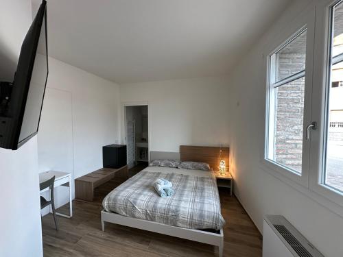 a white bedroom with a bed and a window at LOCANDA LA CAMPAGNOLA orari check in dalle 1130 alle 1530 e dalle 1830 alle 2330 in Vignola