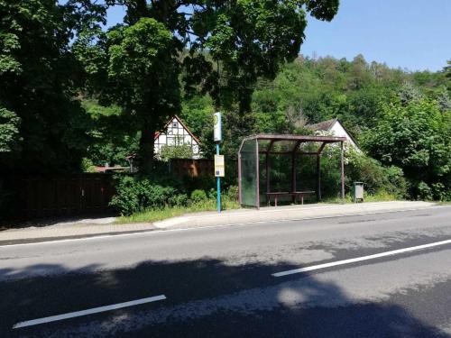 a bus stop on the side of a road at Ferienwohnung Natur pur Mühlental Wernigerode in Wernigerode