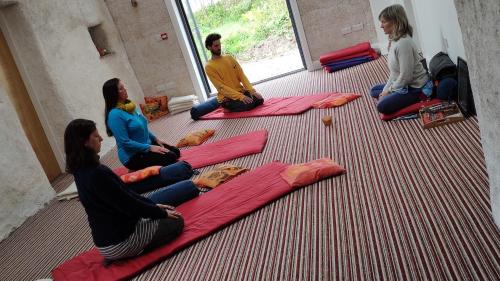 a group of people sitting on mats on the floor at Pure Space in Kilkee