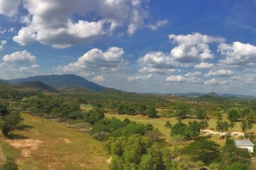 an aerial view of a field with mountains in the background at AFamosa Purple Dream Residence Condotel homestay in Melaka