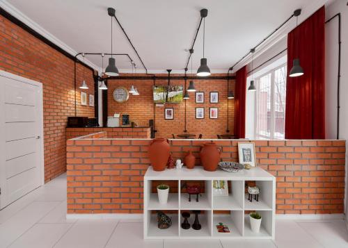 a living room with a brick wall and a counter at HELLO INN budget hotel in Astana
