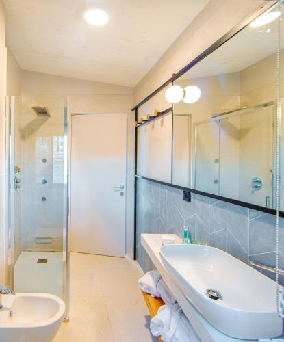a bathroom with a tub and a sink and a shower at Tenuta Delle Ripalte in Capoliveri