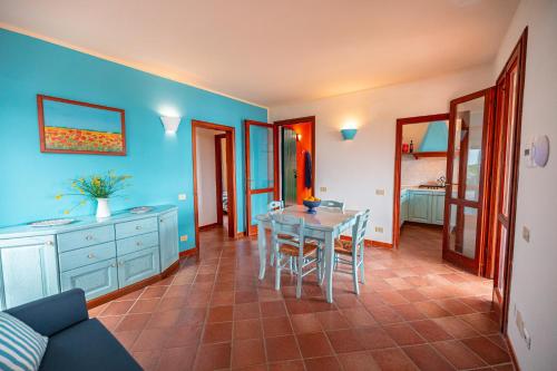 a dining room with a table and blue walls at Tenuta Delle Ripalte in Capoliveri