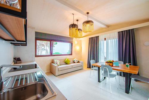 a kitchen and living room with a table and a couch at Tenuta Delle Ripalte in Capoliveri