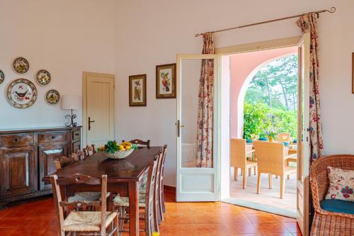 a dining room with a wooden table and a dining room at Tenuta Delle Ripalte in Capoliveri
