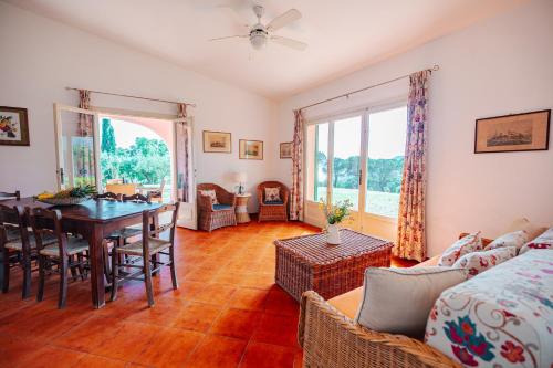 a living room with a table and a dining room at Tenuta Delle Ripalte in Capoliveri