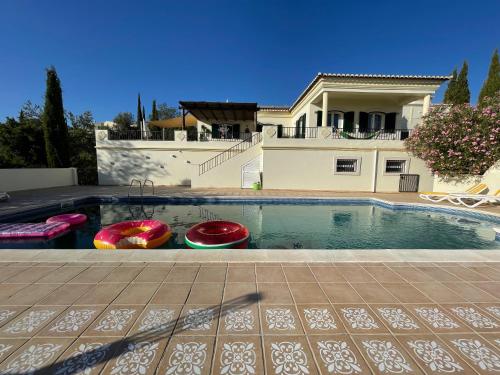 a swimming pool in front of a house at Casa do Monte in Loulé