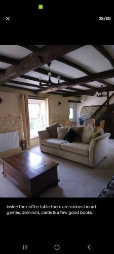 a living room with a couch and a coffee table at The Barn in Saltash