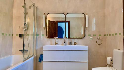 a bathroom with a sink and a mirror at Casa do Monte in Loulé