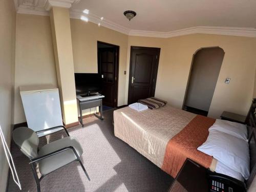 a hotel room with a bed and a desk at Habitación Privada-Corso Cbba 23 in Cochabamba
