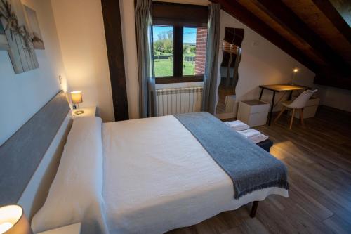 a bedroom with a large bed and a window at La casita del abuelo in Galizano
