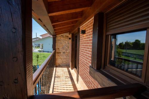 a view from the porch of a house with a window at La casita del abuelo in Galizano
