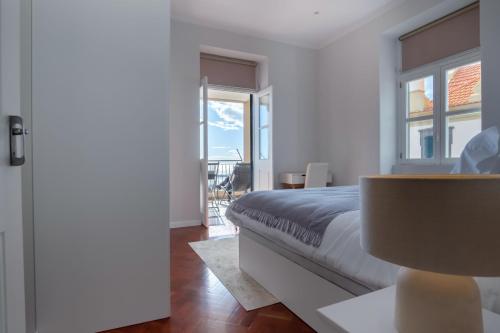 een slaapkamer met een bed en uitzicht op een balkon bij Pi Houses in Funchal