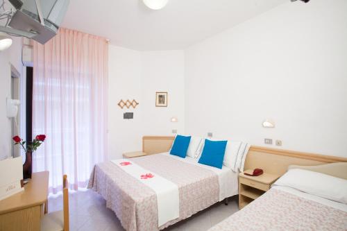 Postel nebo postele na pokoji v ubytování Hotel Cola Frontemare