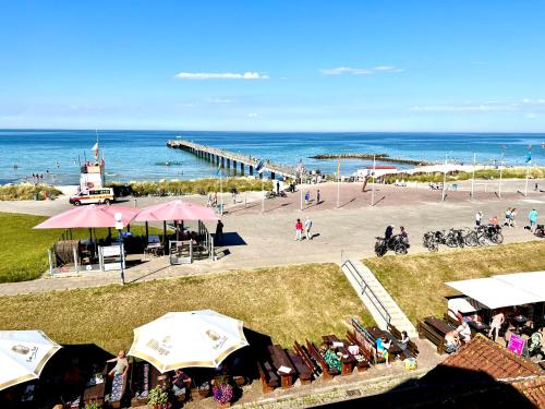 an overhead view of a beach with people sitting under umbrellas at Traum Ostseemeerblick in Schönberger Strand