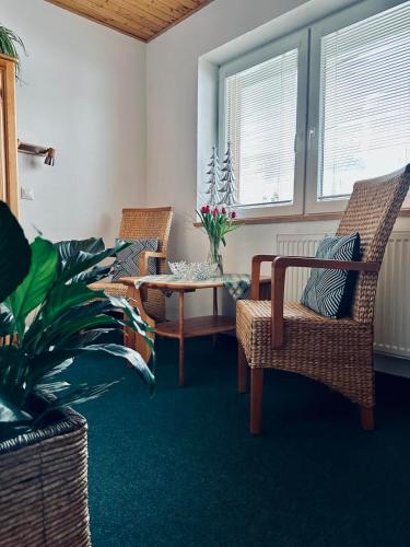 a living room with two chairs and a table at Penzion pod Brehom in Terchová