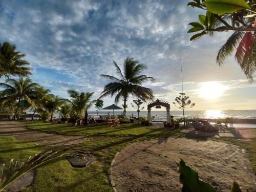 a park on the beach with palm trees and the ocean at Keraton Krakatoa in Banten