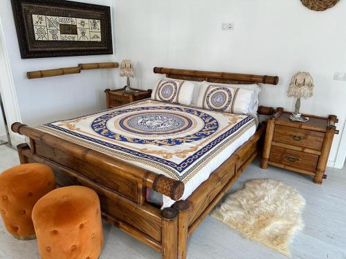 a bedroom with a wooden bed with two chairs at Adeje Luxury Apartment in the south of Tenerife in Adeje
