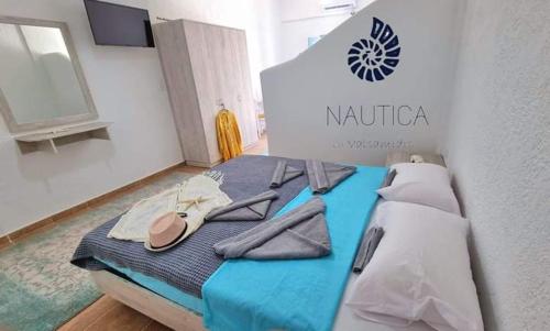 a room with a bed with a sign on it at Nautica by Valsamidis in Vlychádia